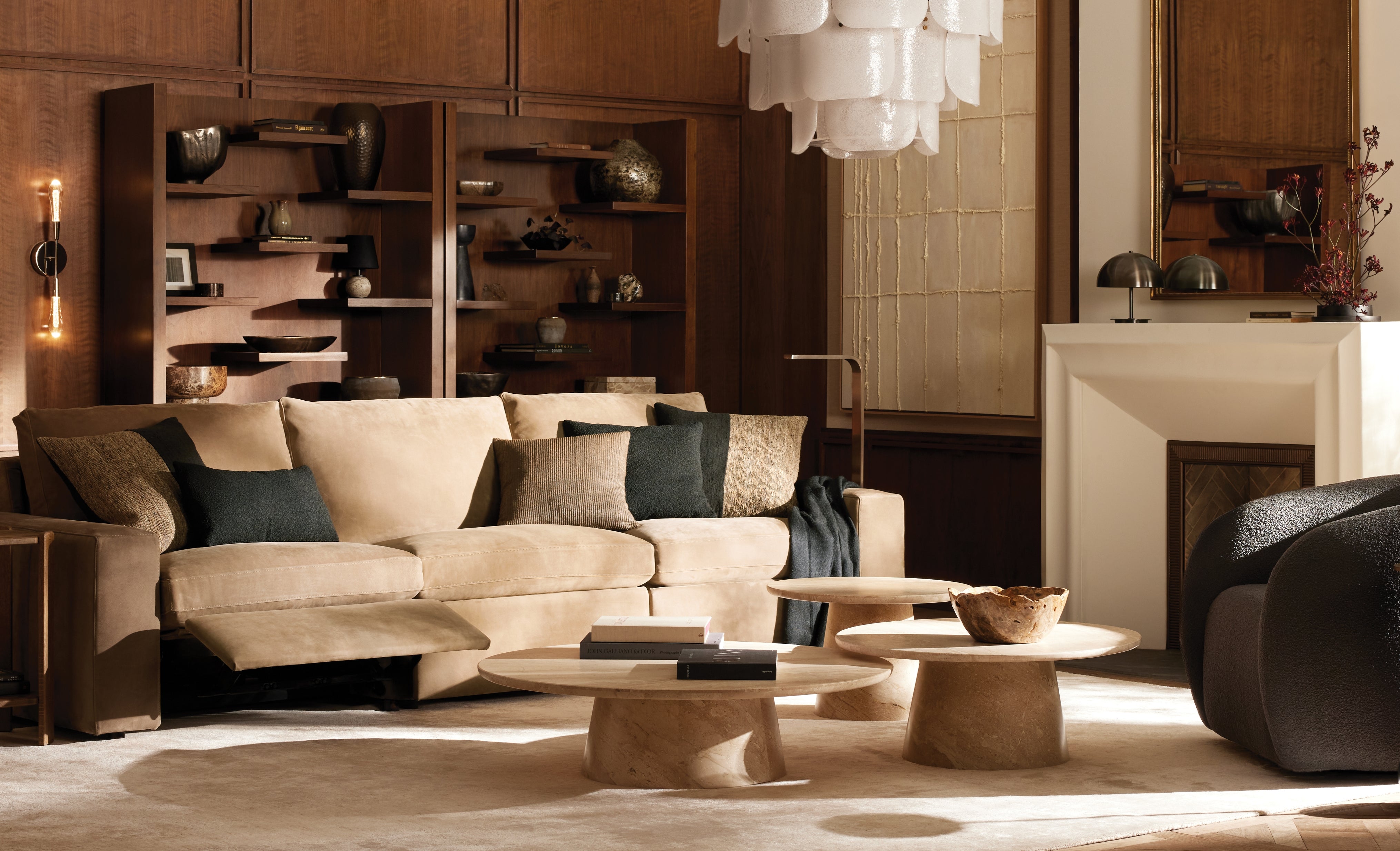 Modern living room with beige sofa, coffee table, and decorative items.