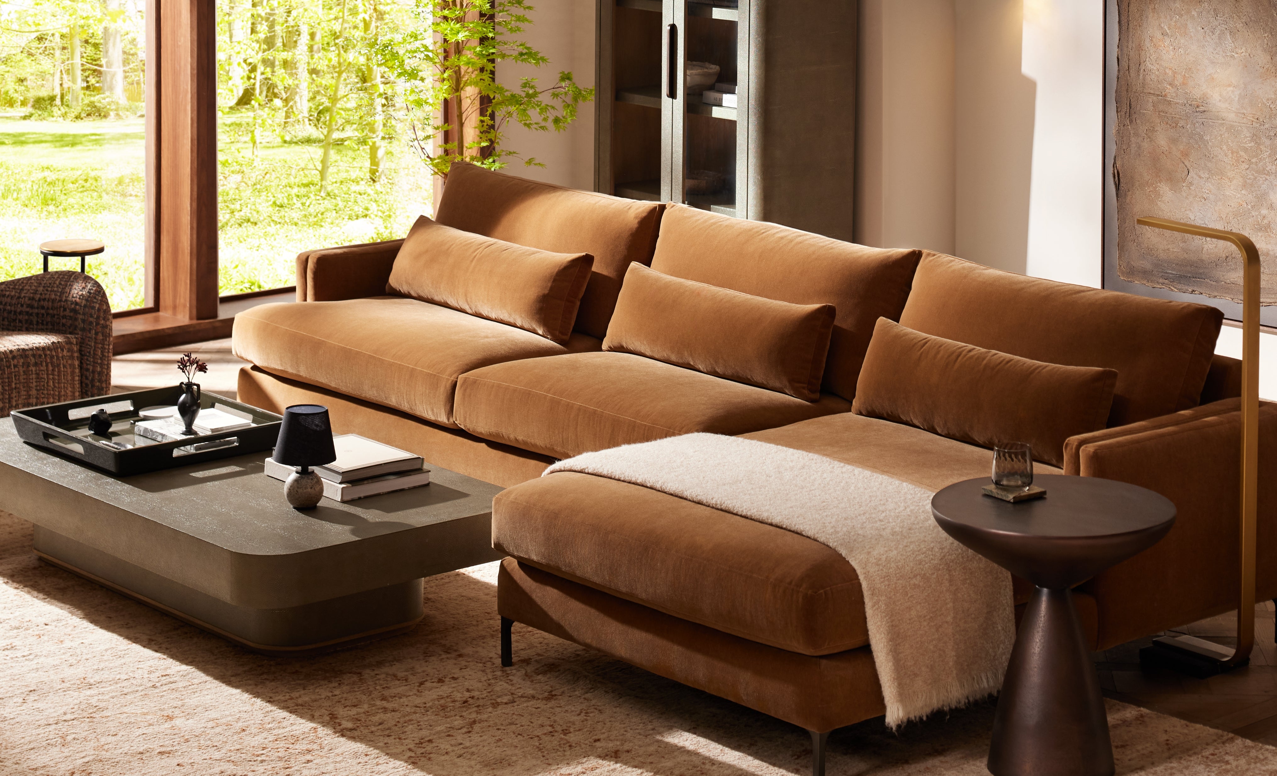 Brown sectional sofa in a living room with a coffee table and decorative items.